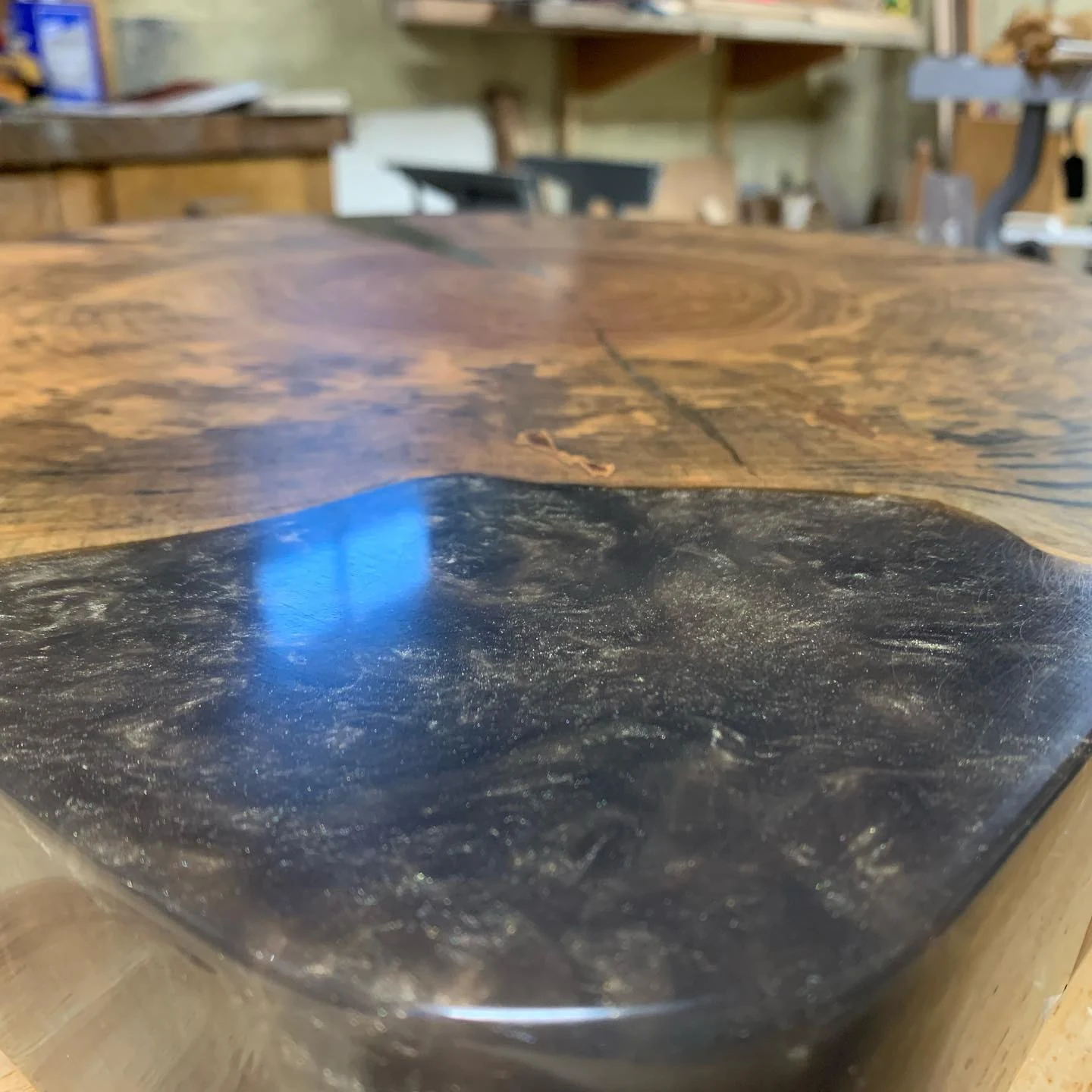 The asymmetric wood-and-resin top before the base, from the earlier archive photograph.