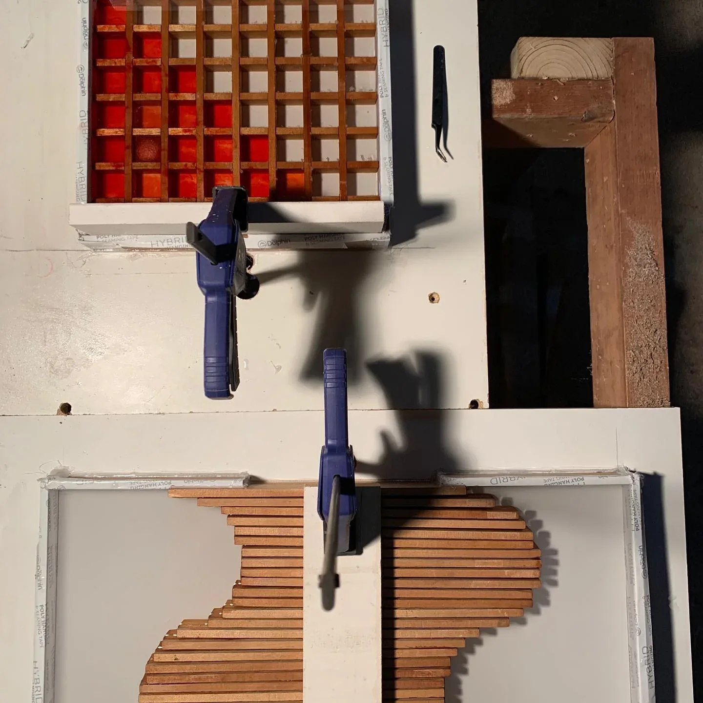 Slatted birch tabletop components clamped during fabrication.