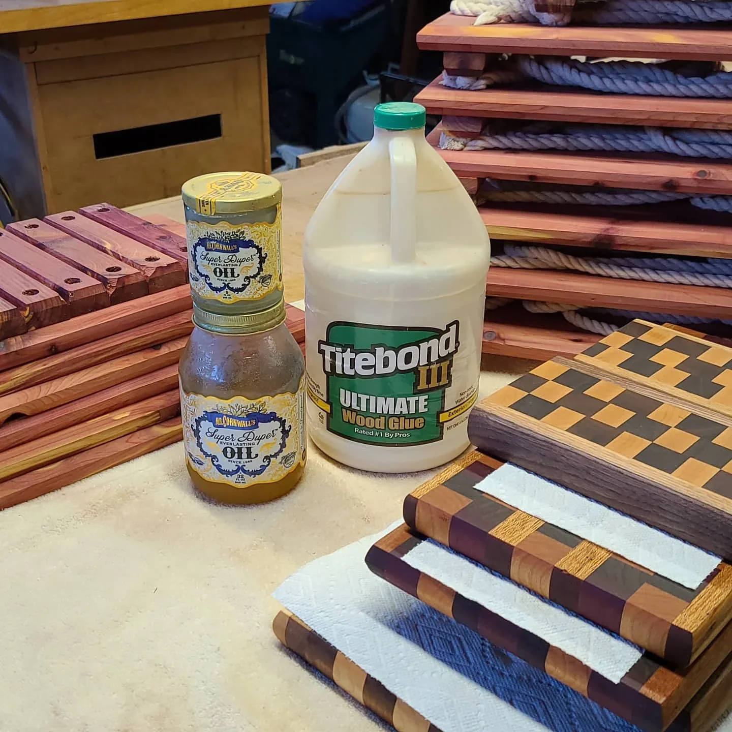 A collection of patterned cutting boards on the workshop bench.