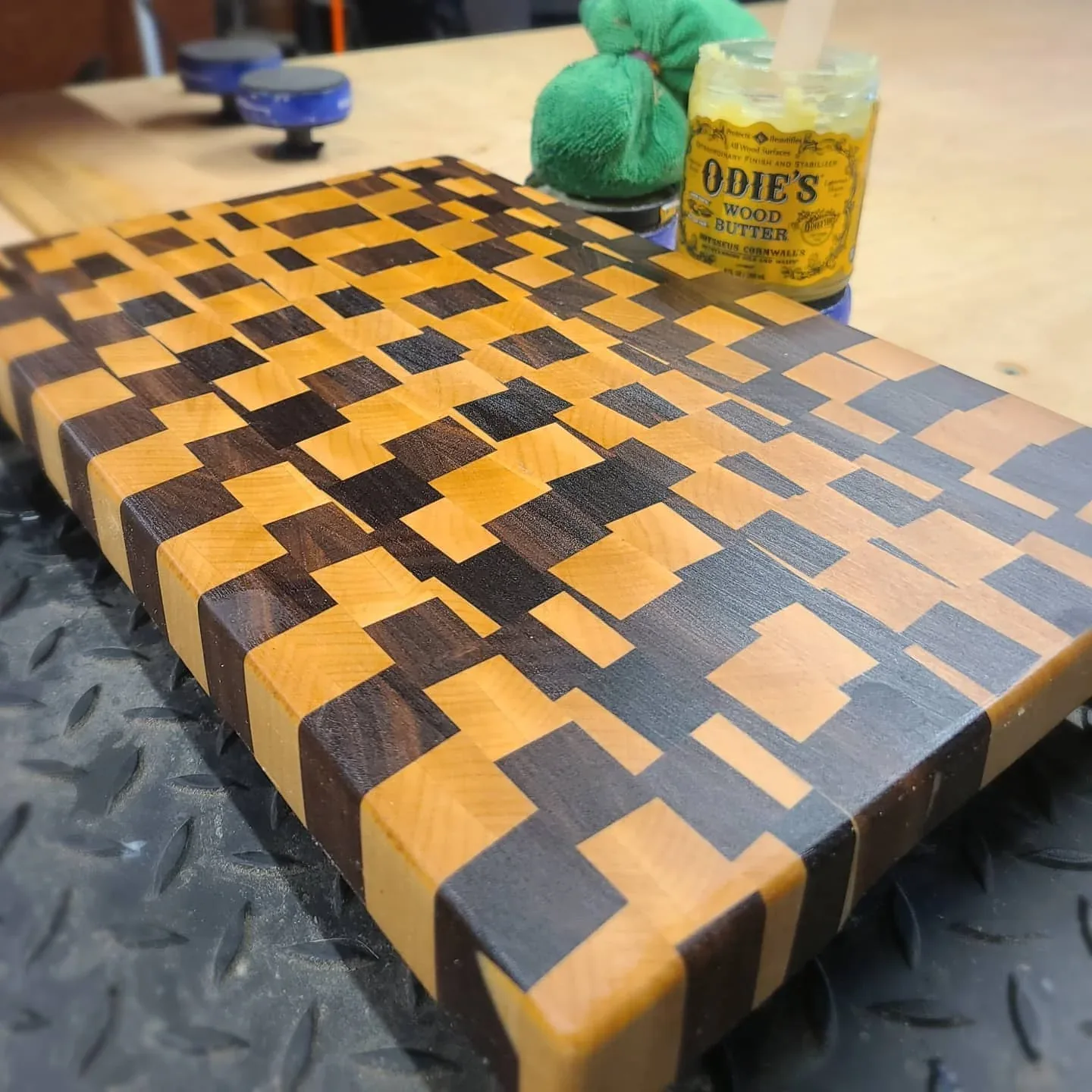 A cutting board with an irregular contrasting end-grain pattern.