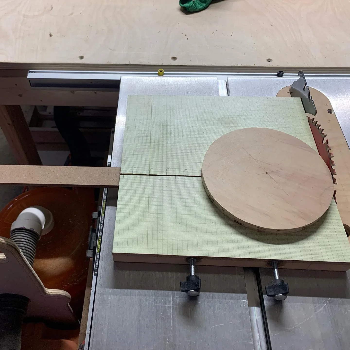 The table-saw circle jig with a circular wooden blank.