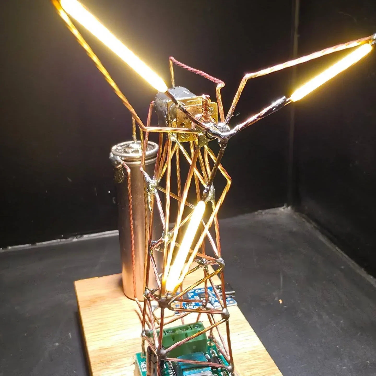 Freeform circuit sculpture with exposed wire structure and illuminated elements.