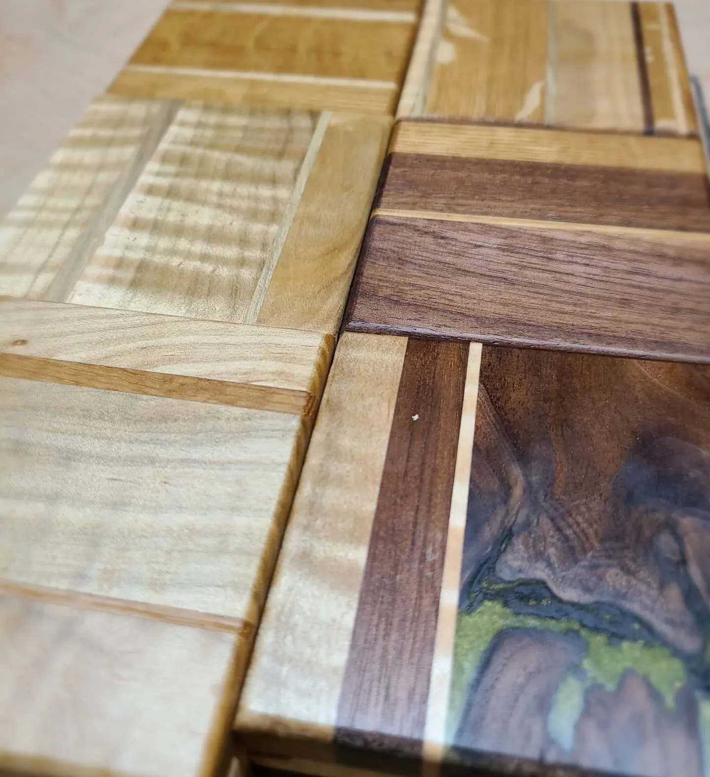 A group of handmade coasters showing figured wood and colored resin.