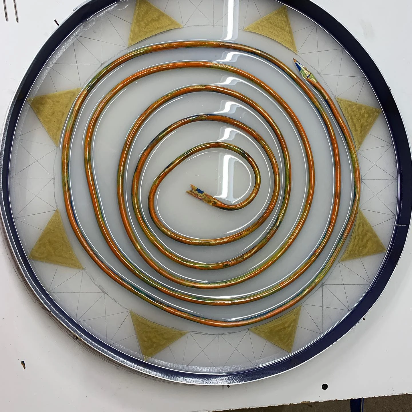 Copper spiral and triangular decoration during the resin process.