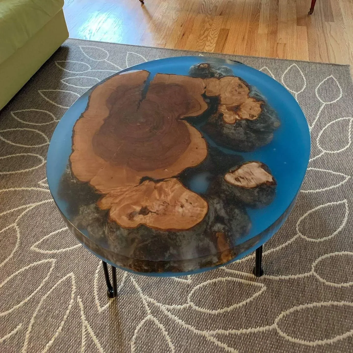 An early round table with irregular wood sections and blue resin.