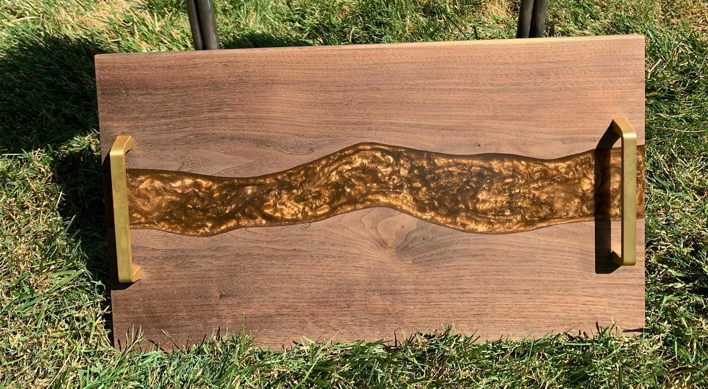 Handled wood and gold-resin serving tray, cropped from the original July collection photograph.