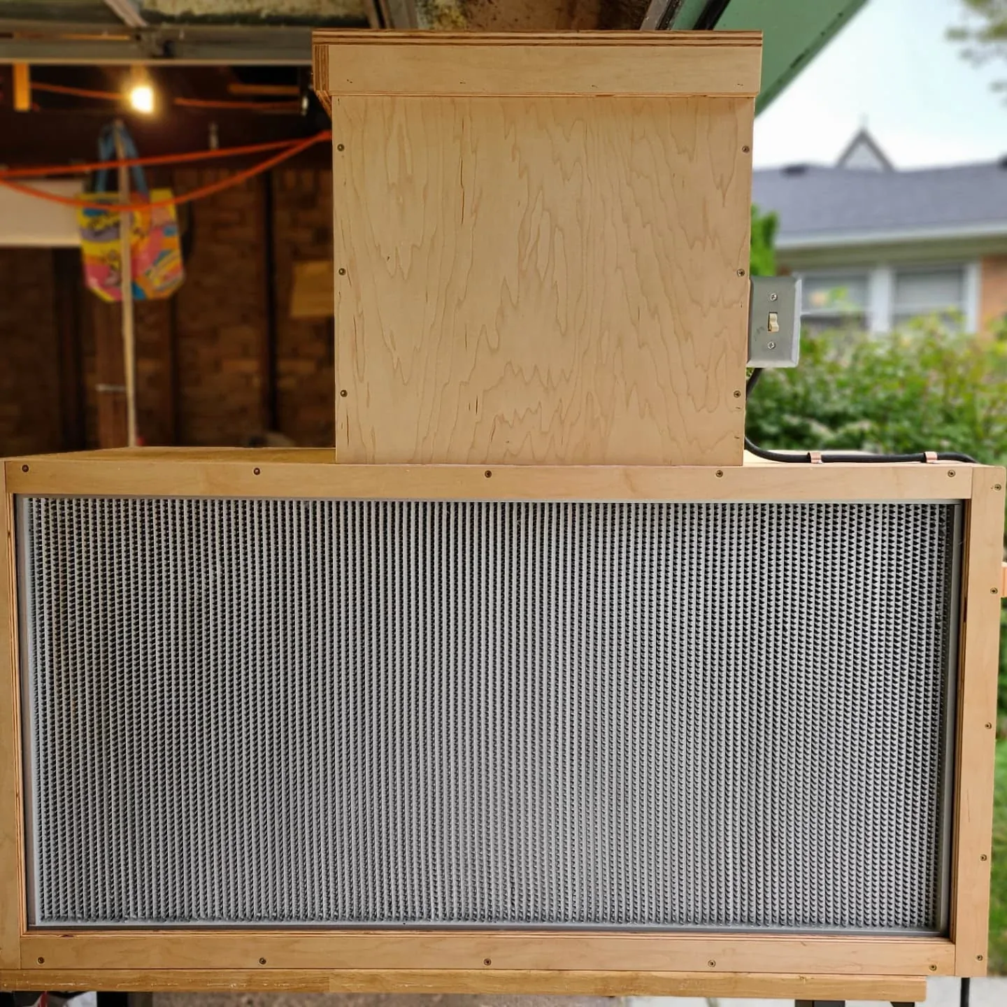 The wooden flow-hood enclosure, with a large filter face and a box above it.