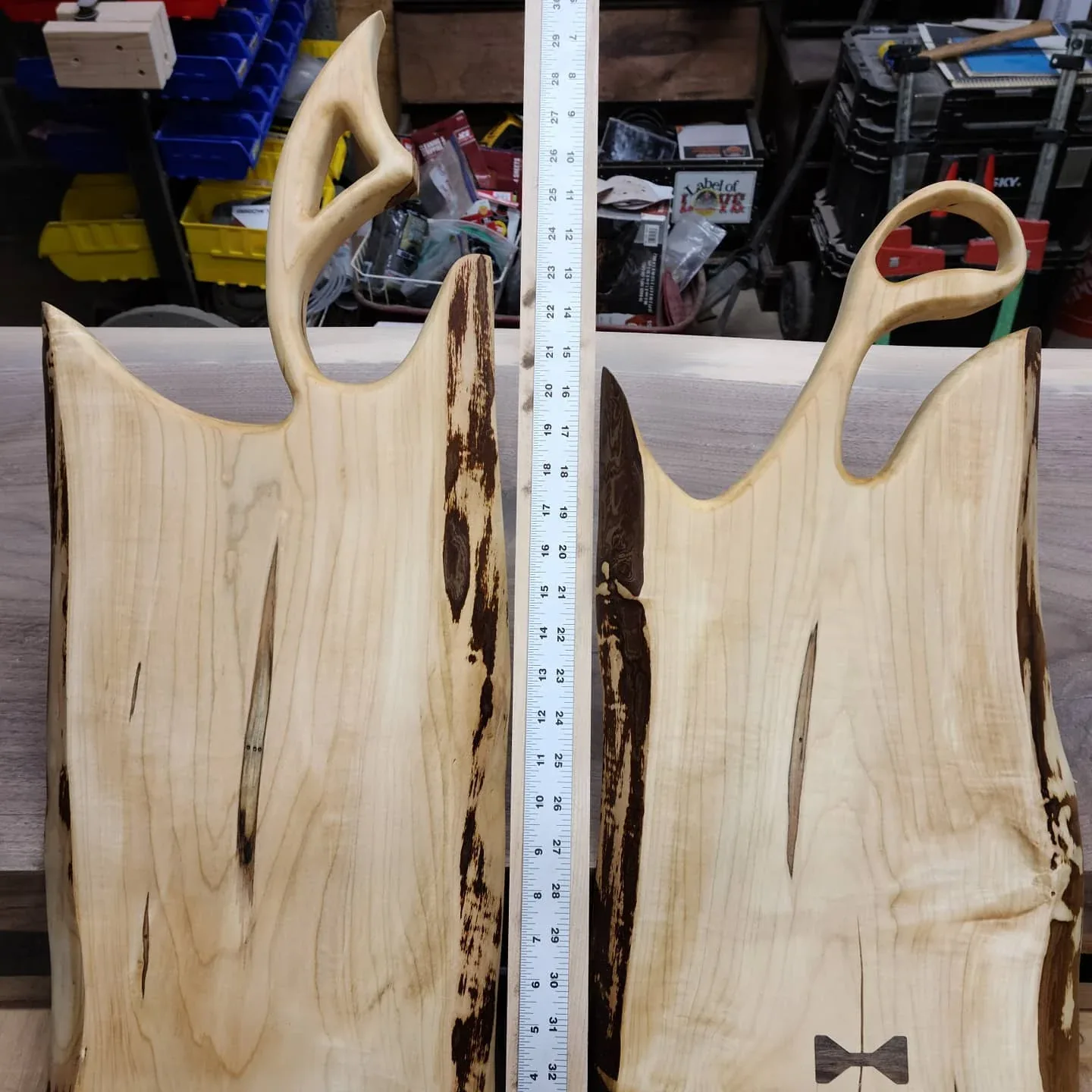 The paired live-edge ambrosia-maple serving boards, with handles and bow-tie inlays.