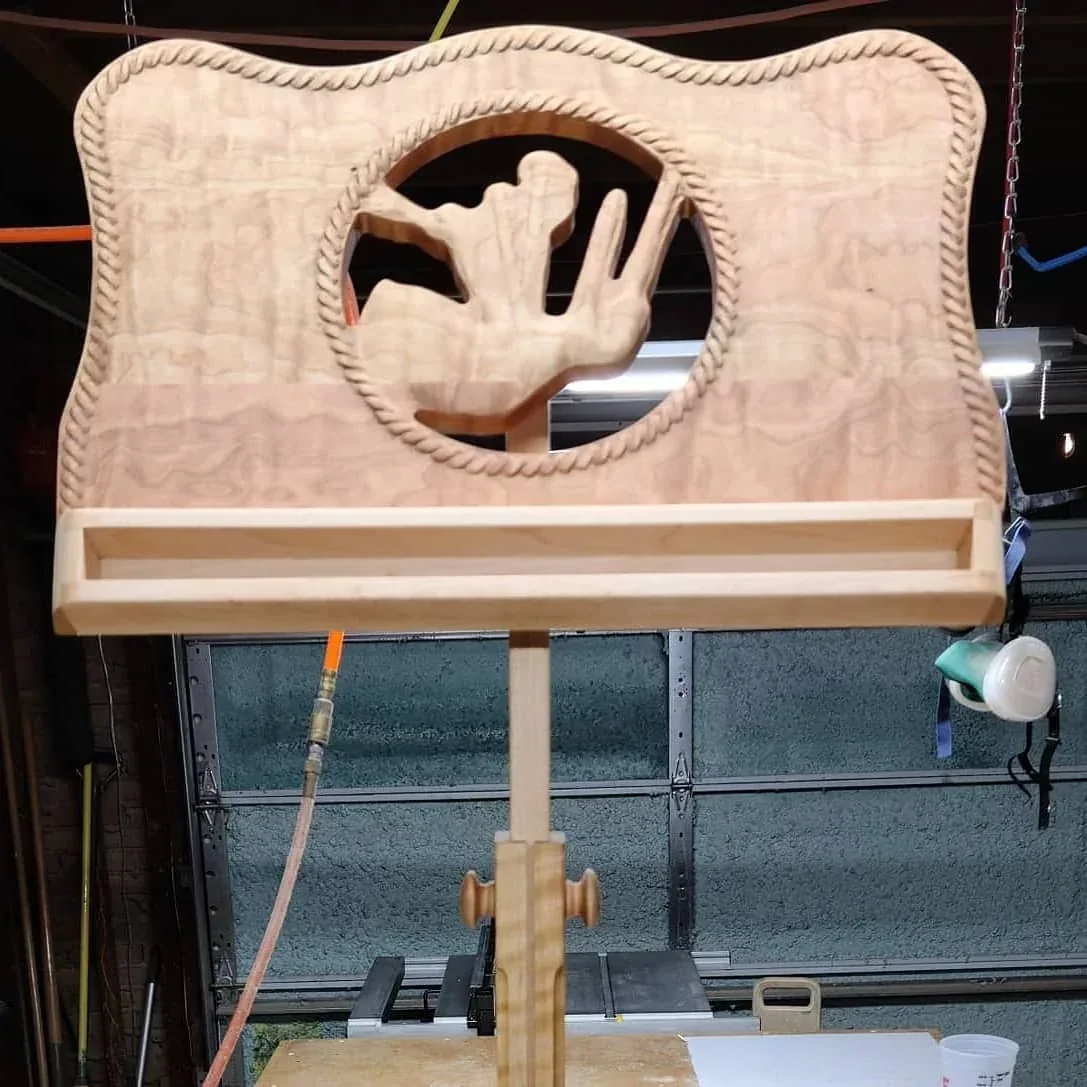 Front view of the custom cherry music stand in the workshop.