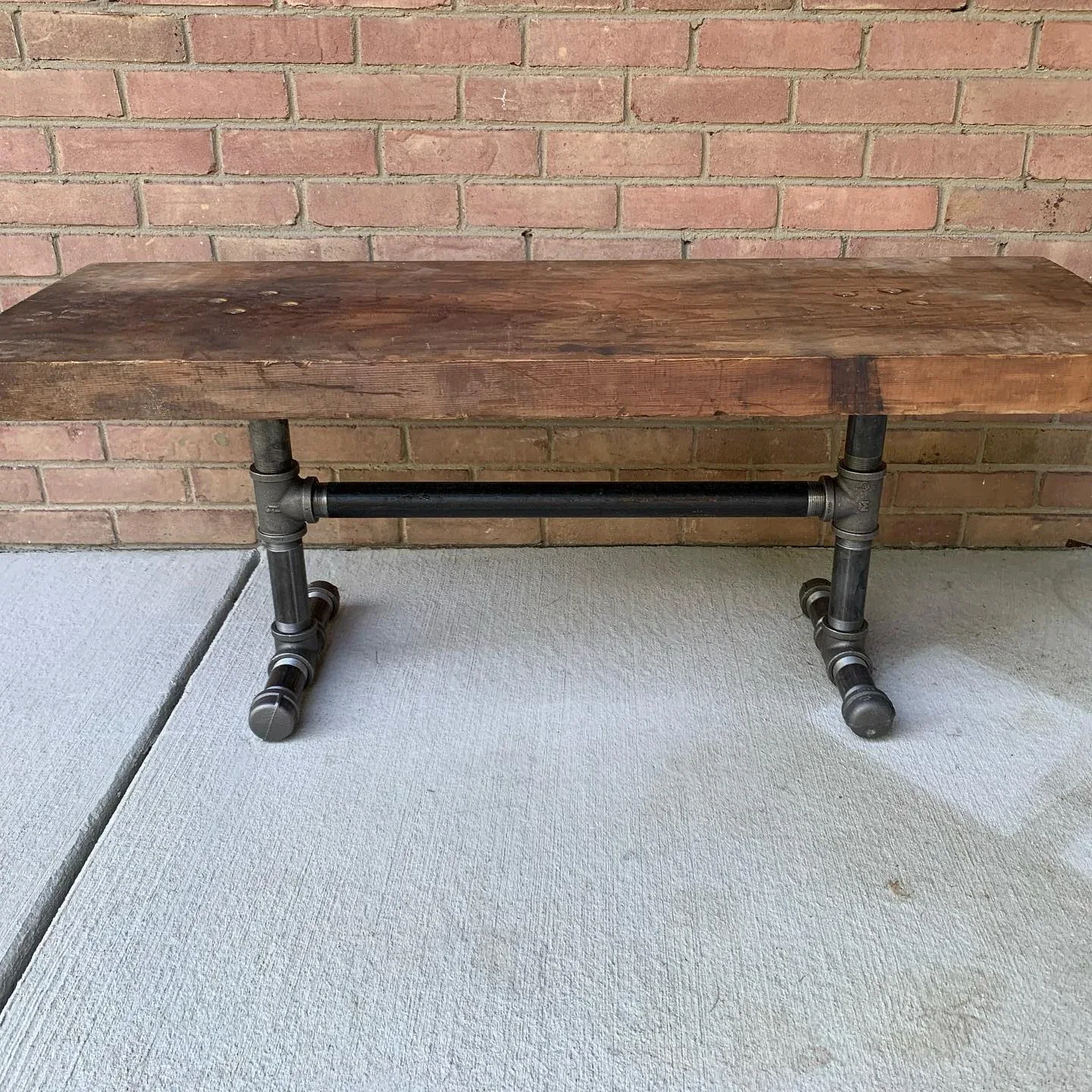 Reclaimed Douglas-fir bench top on a black-pipe base.