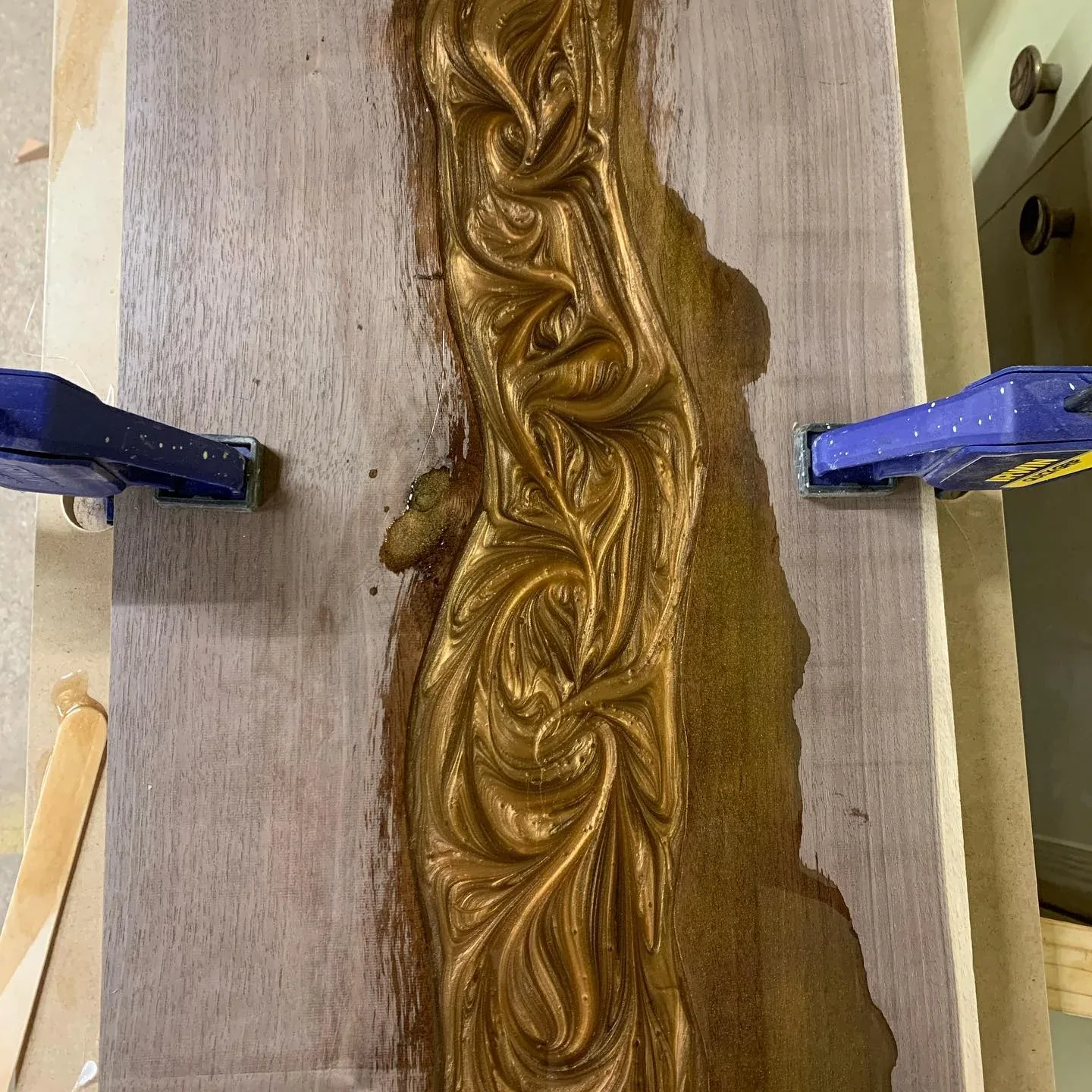 Swirl pattern worked into the thickening resin between two natural wood edges.