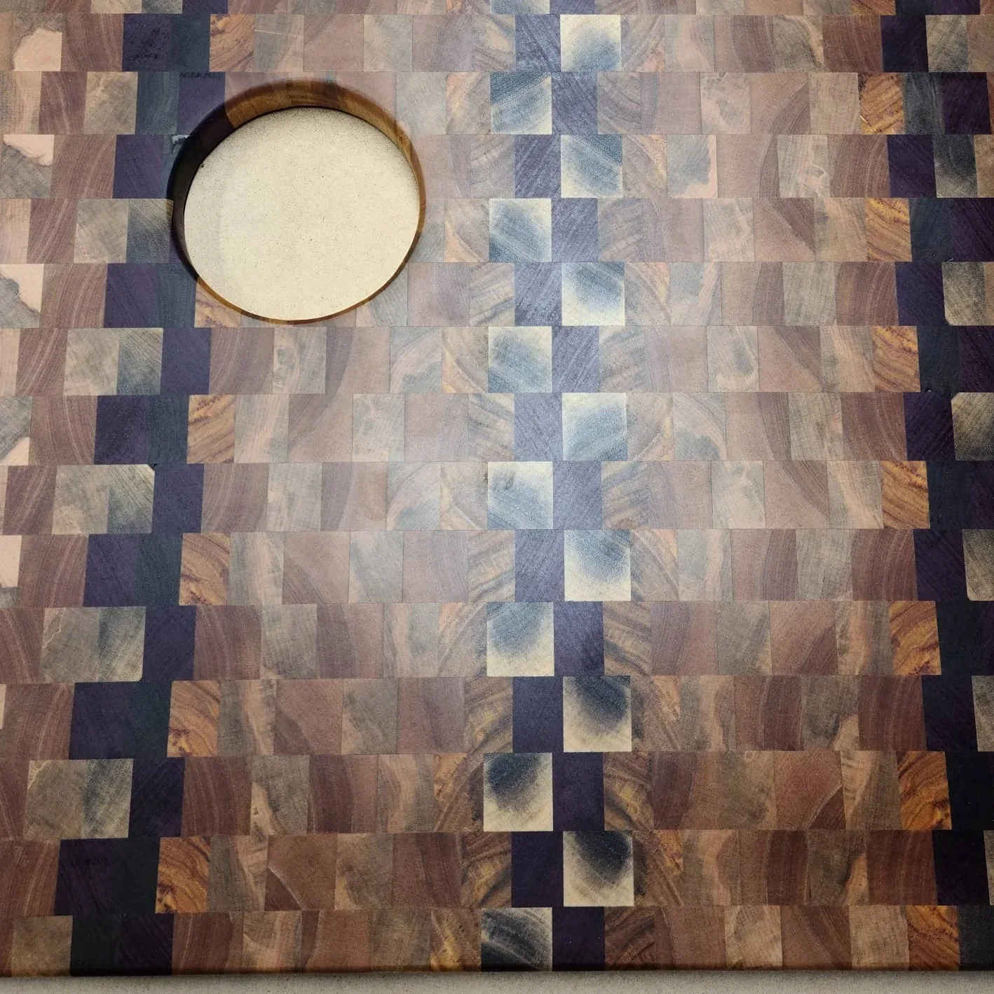 The patterned end-grain RV sink insert, including its circular opening.