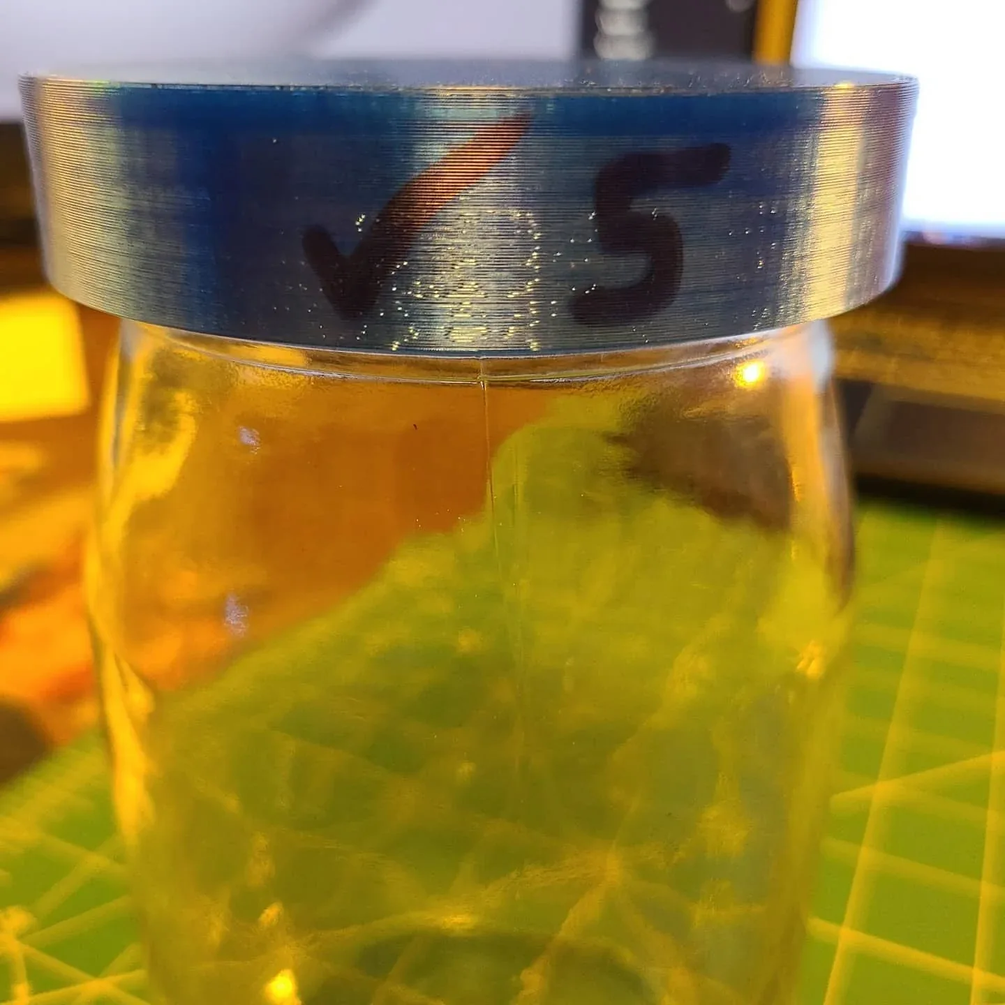 The blue printed lid fitted to its jar in the original prototype photograph.