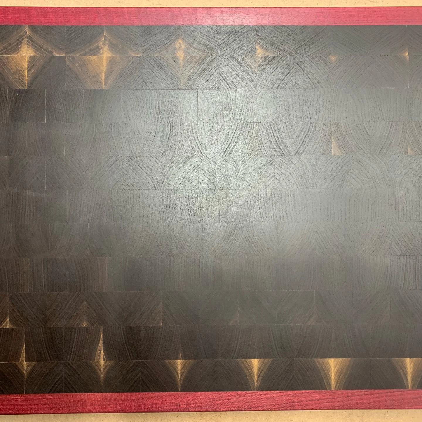 Walnut end-grain cutting board with a purpleheart border.