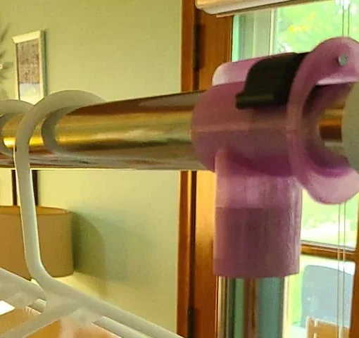 Cropped detail of the purple replacement fitting installed at the wardrobe rail joint.
